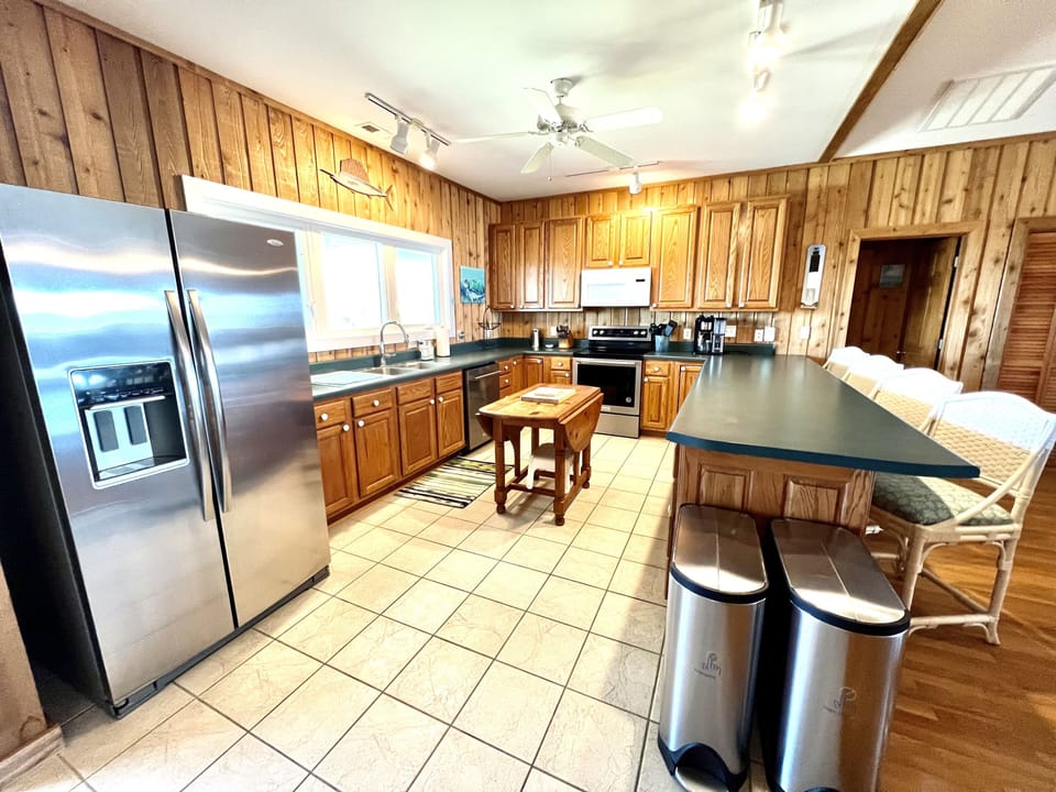 Fully stocked kitchen with breakfast bar.