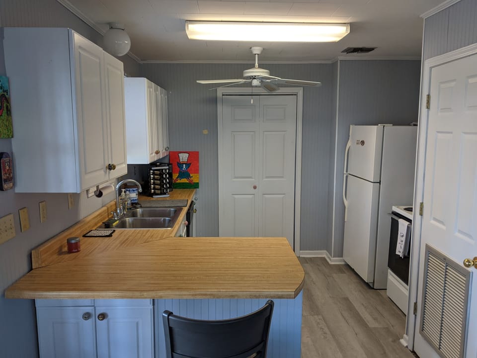 Beyond kitchen is pantry door. Lots of room for grocery storage, ice chest, etc 