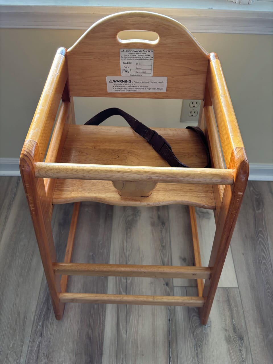 High chair with safety strap. Stored in Master bedroom closet.