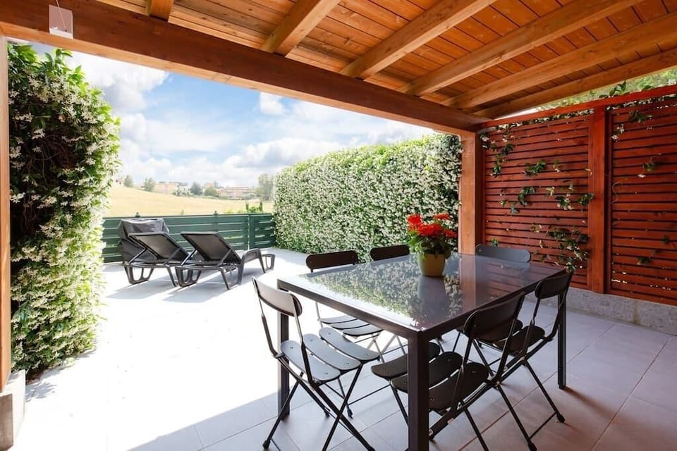 Private patio with outdoor furniture, sun loungers and barbecue