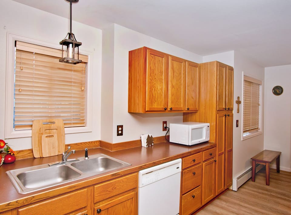 Kitchen view with dishwashermicrowave 