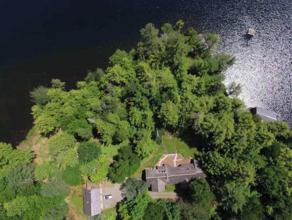 Aerial view of house and point, with wooden raft visible