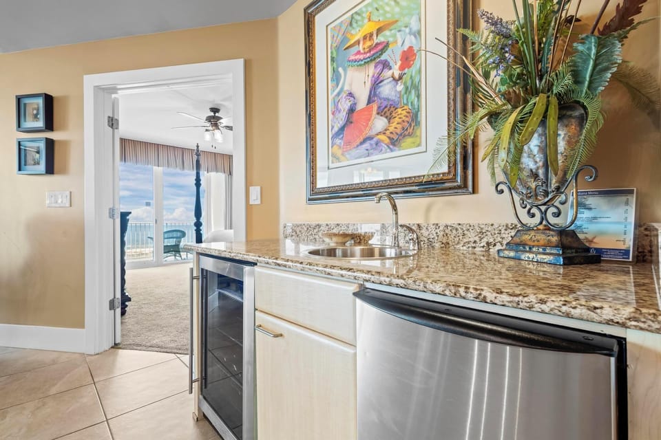 Wet bar with an ice maker and wine cooler