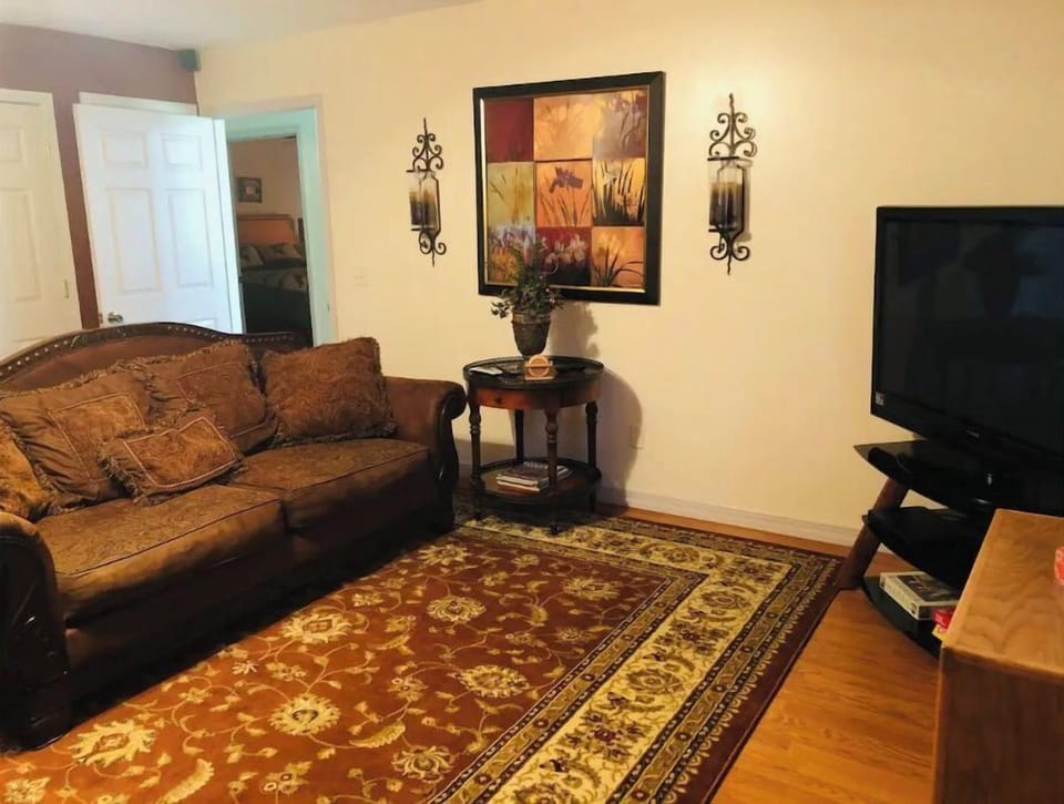 Couch and love seat in the living room & big screen tv with dvds and tv apps.