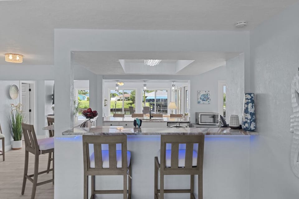 Counter-height chairs offer a casual spot to sit and overlook the kitchen—perfect for morning chats or keeping the cook company.