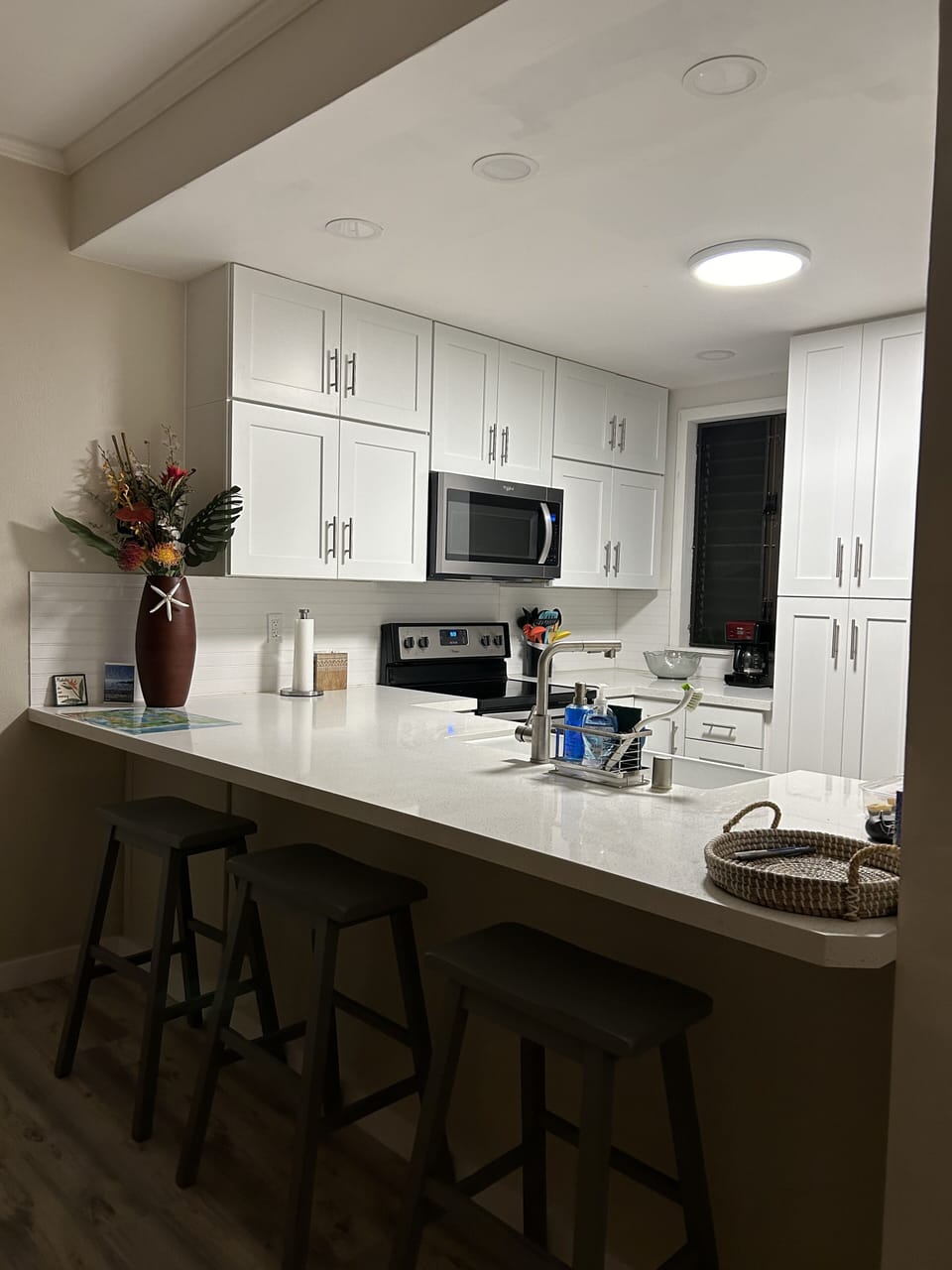 Kitchen with three counter stools