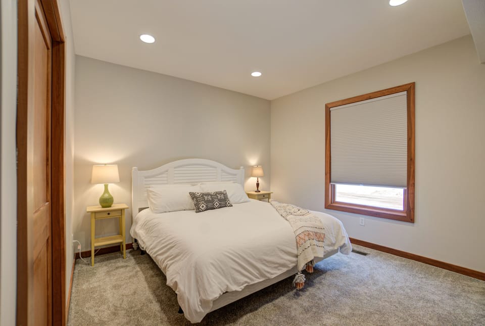 Comfortable primary bedroom with cozy bedding and blackout curtains.
