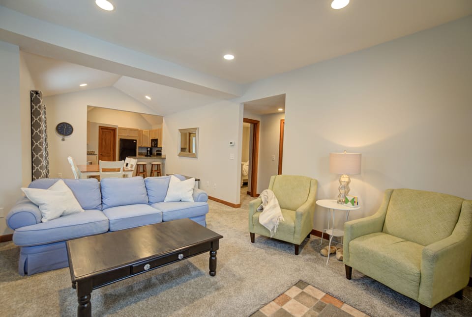 Comfortable primary bedroom with cozy bedding and blackout curtains.