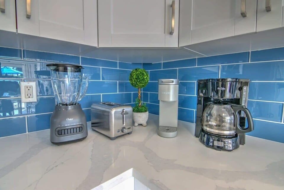 The Kitchen Includes Small Electronic Gadgets Including a Regular and Keurig Coffee Maker, a Blender and a Toaster