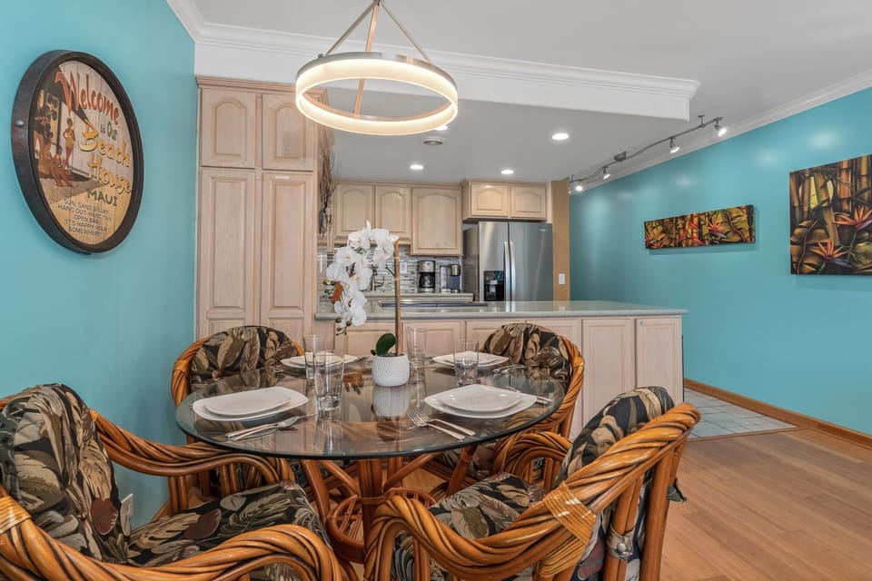 Relax in your tropical-inspired living space with coastal breezes from the ceiling fan, soft lighting, and comfortable seating that flows seamlessly into your fully equipped kitchen.