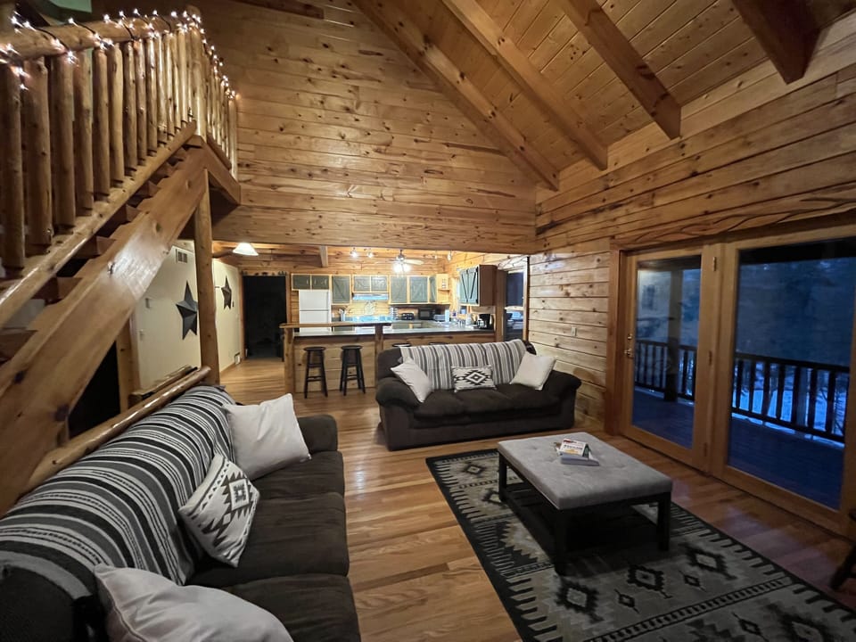 The living room has a wood framed glass swing door which leads to upper deck.