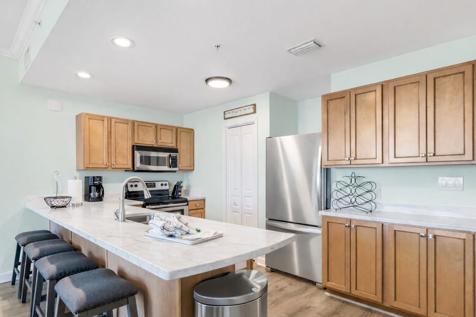 full kitchen with stainless steel appliances and quartz countertops