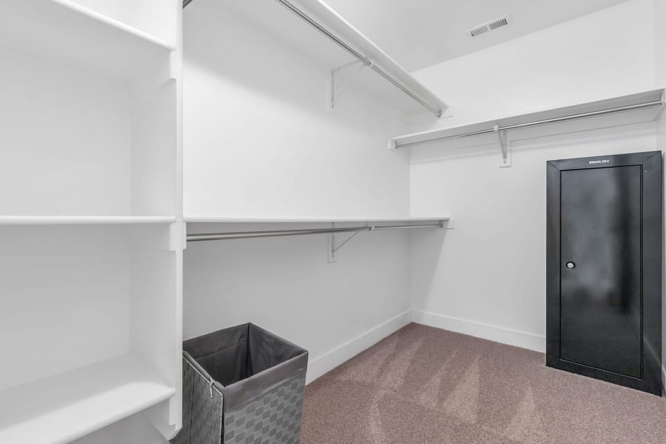 Master bedroom closet with gun safe/safe.