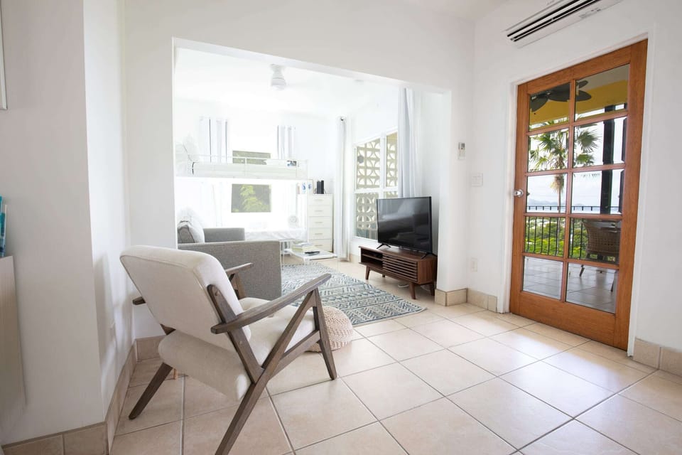 Comfortable modern living space with Apple TV and games.