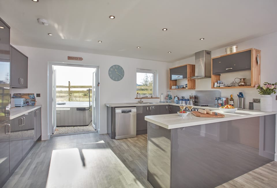 Treveth Lowen, St Minver. Ground floor: Kitchen with American style fridge/freezer, dishwasher and french doors to outside