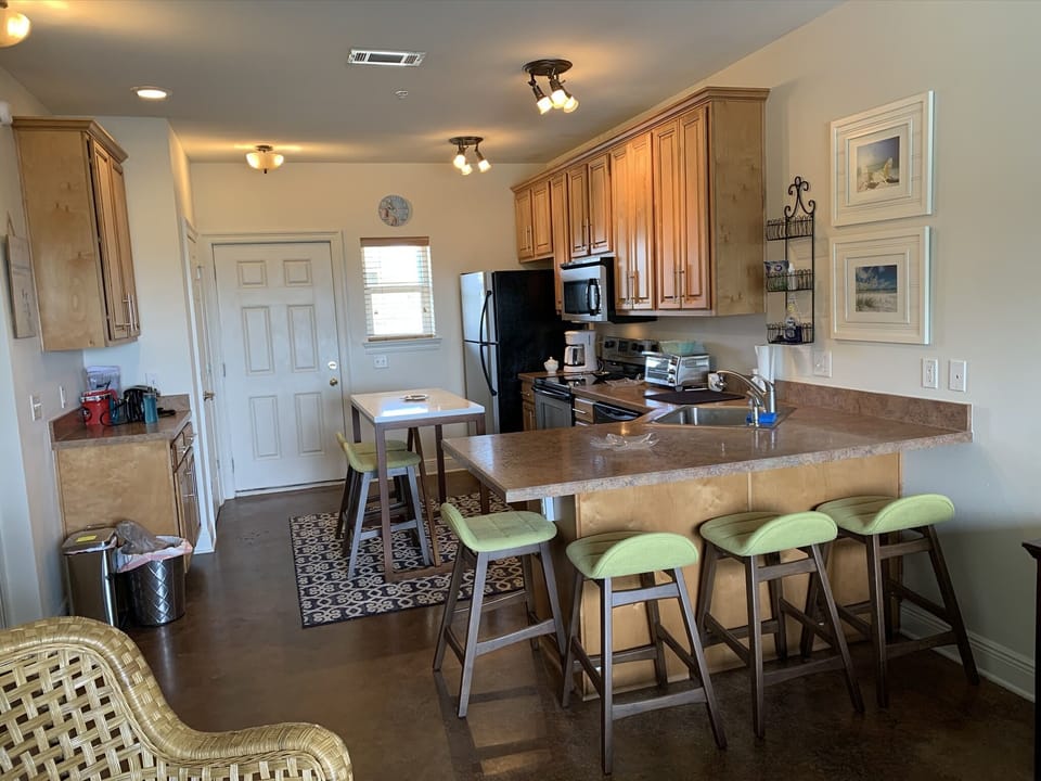 Entrance through fully stocked kitchen with seating for 6 inside. 