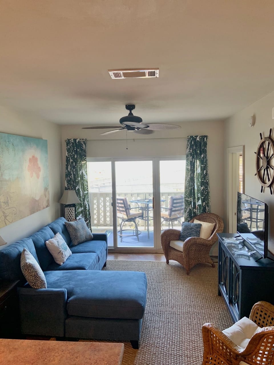 Living room with queen sofa bed, TV, & balcony overlooking the Santa Rosa sound 