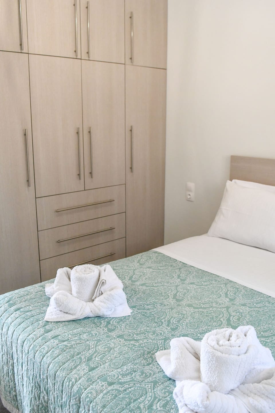 The second bedroom with a comfortable bed and a large wooden wardrobe!