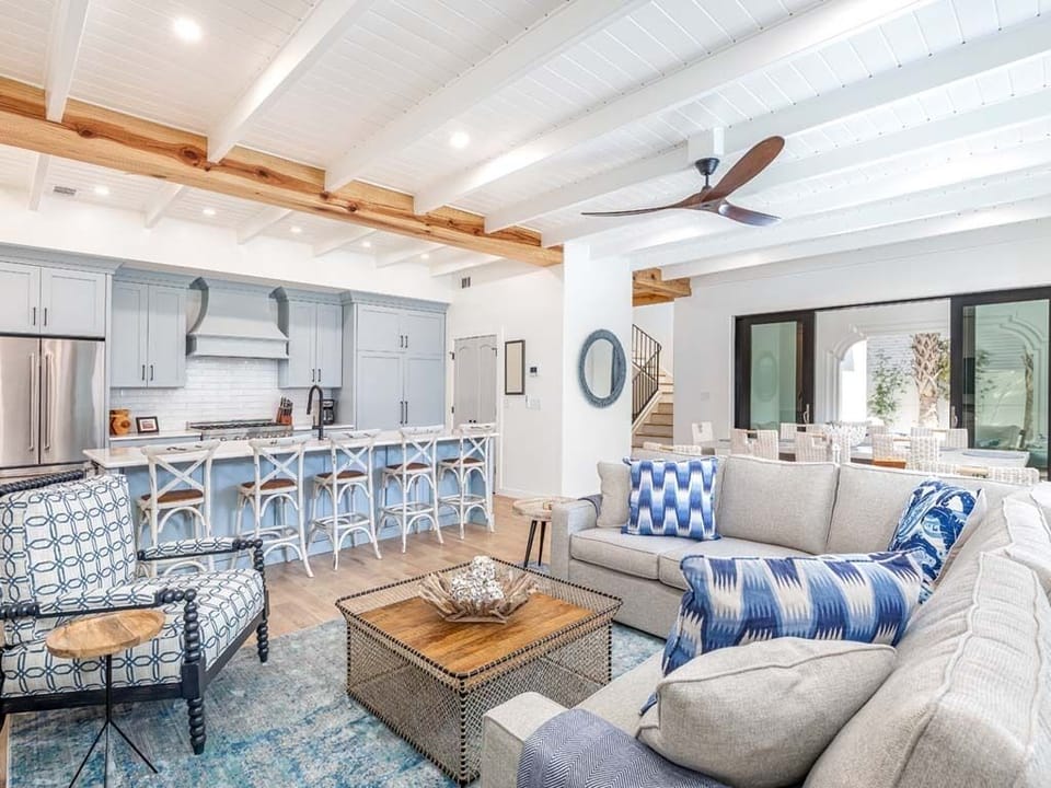 Open plan dining and living areas looking out to pool and patio