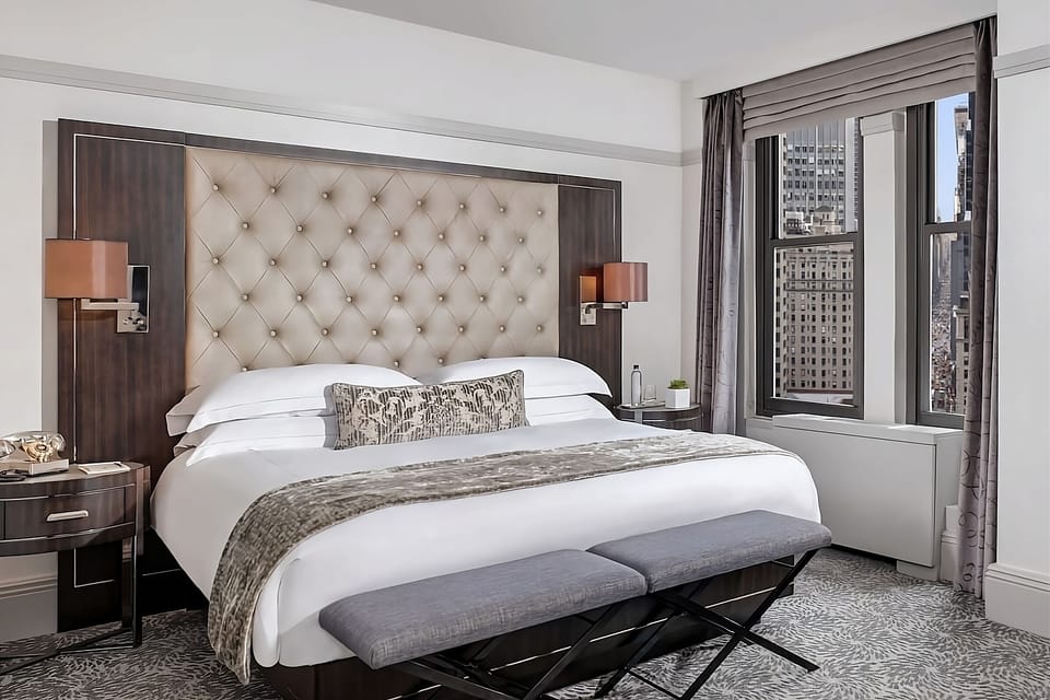 Unwind in a plush king bed with skyline views.