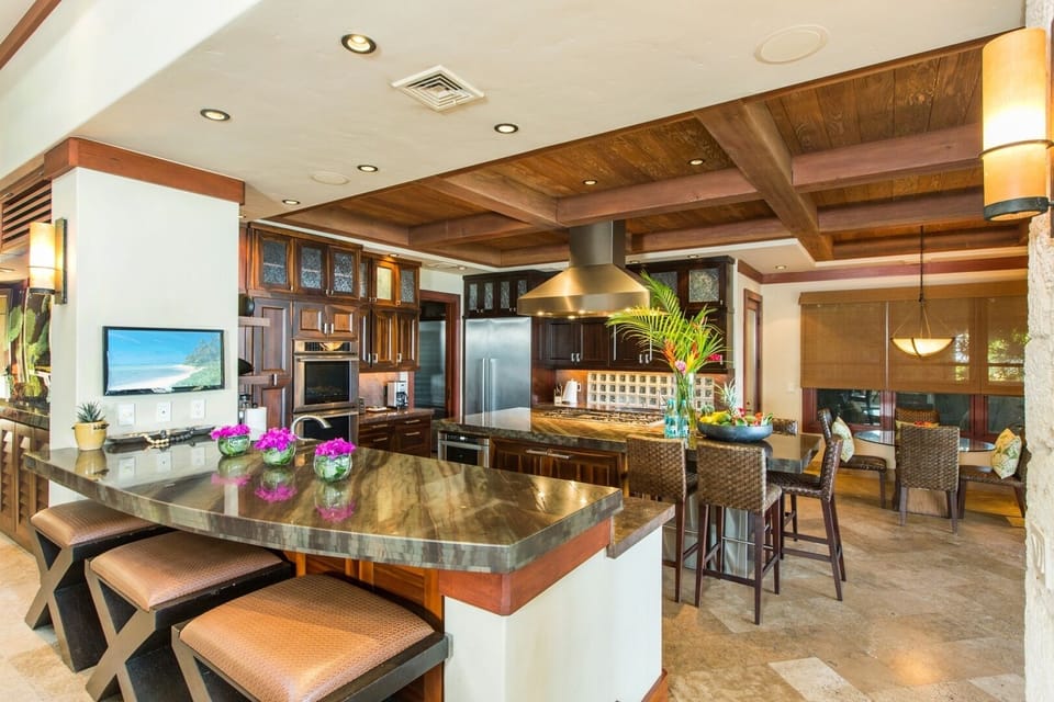 The chef's kitchen combines premium appliances, rich wood finishes, and generous space for cooking and gathering.