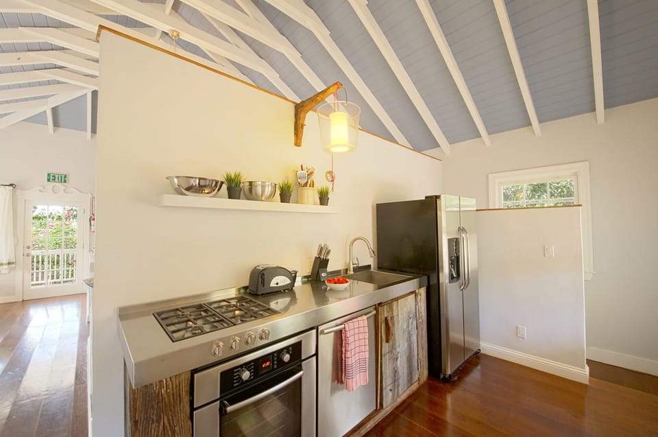Recently remodeled kitchen with stainless steel counter and modern appliances.