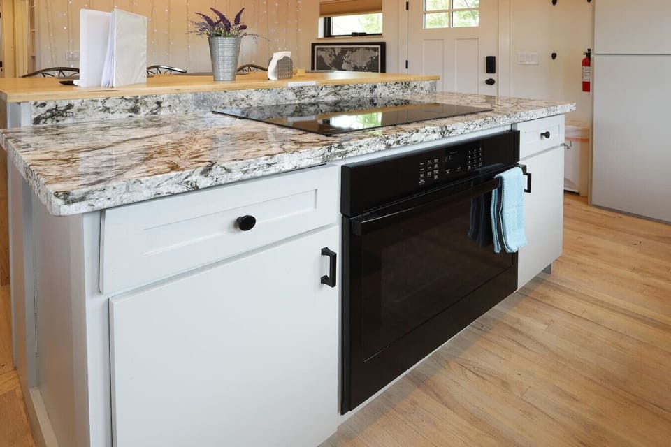 Spacious kitchen island with modern cooktop and plenty of counter space for meal prep.
