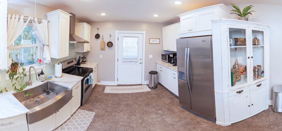 Fully stocked kitchen, back deck and backyard located out the back door. 