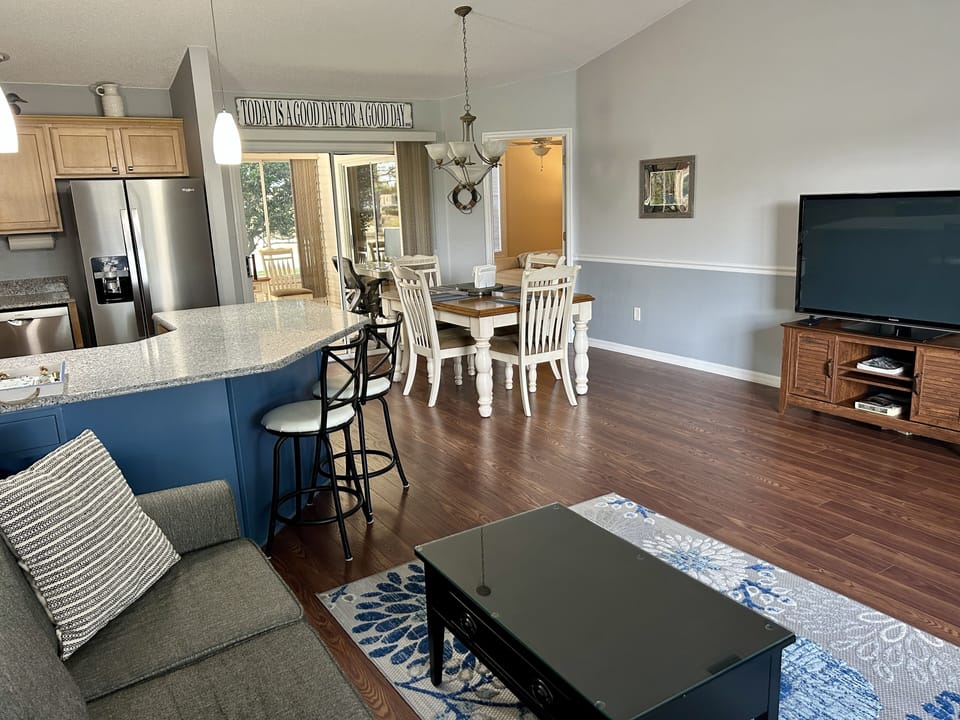Spacious room with cathedral ceilings and  comfy couch and chairs.