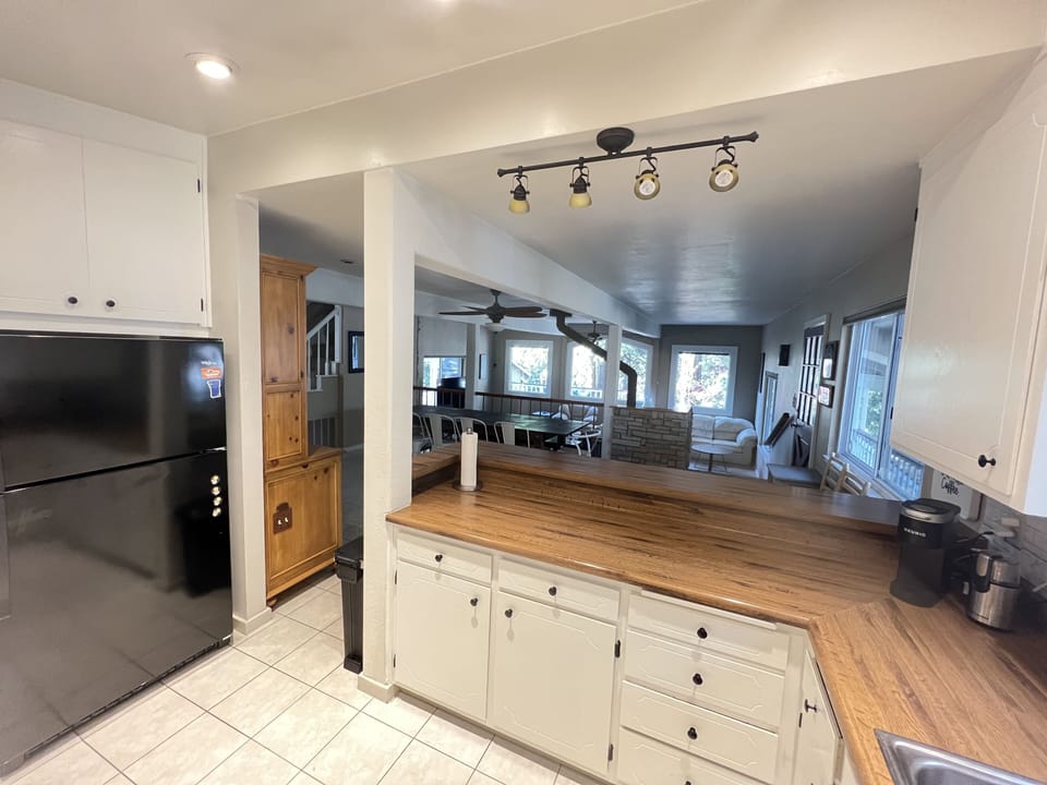open kitchen with 3 bar stools