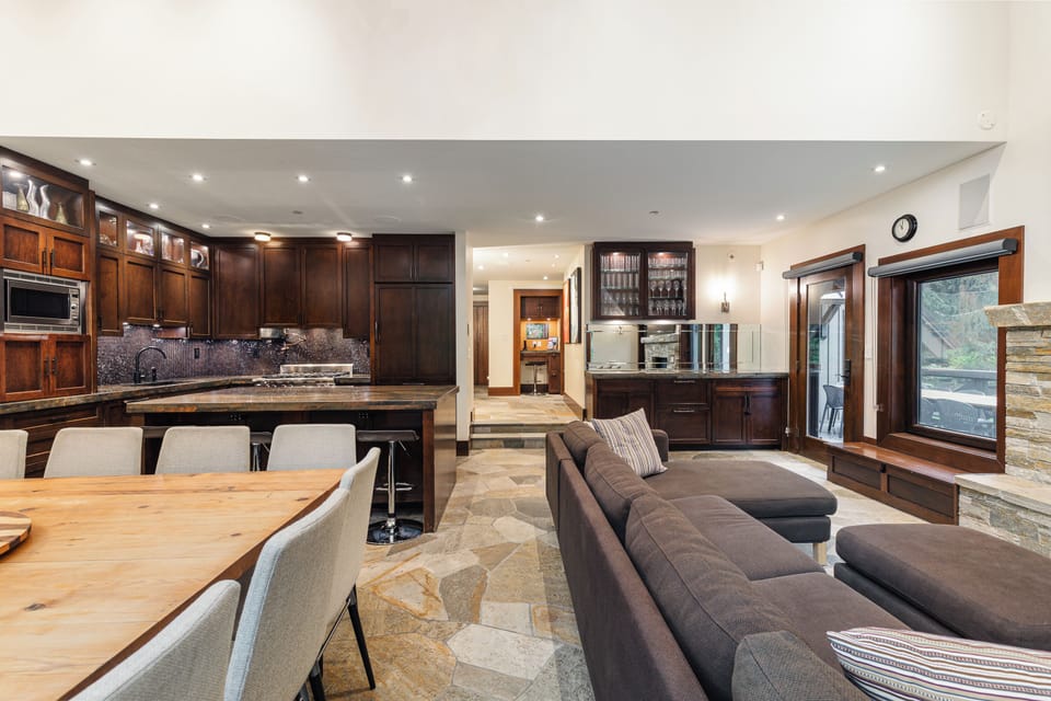 Main level open-plan living / dining / kitchen with fireplace