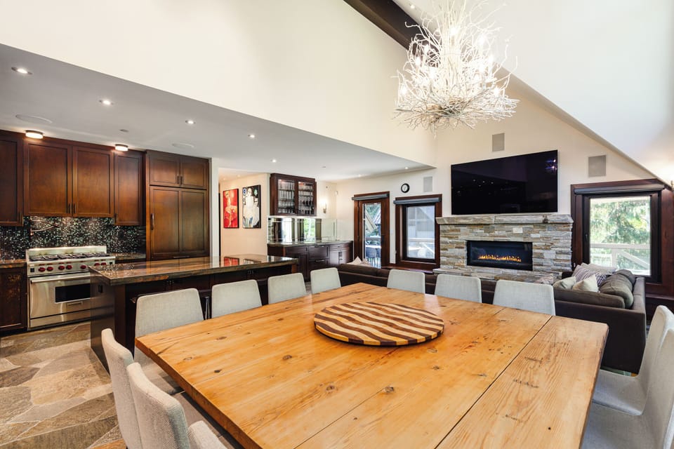 Main level open-plan living / dining / kitchen with fireplace