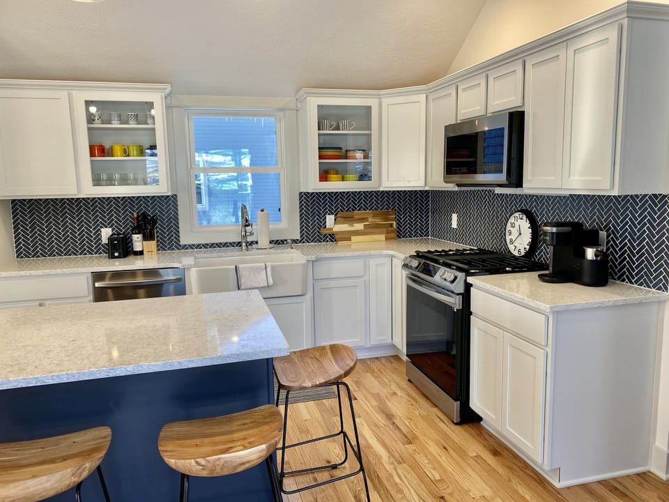 Farm sink, stove and microwave in kitchen