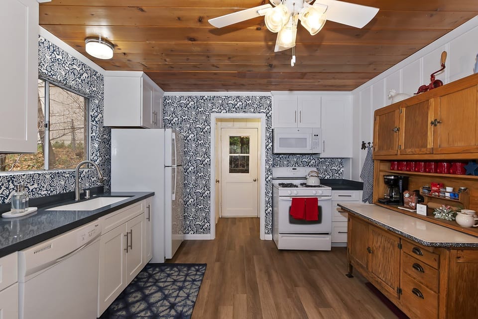 Fully stocked kitchen with coffee bar.