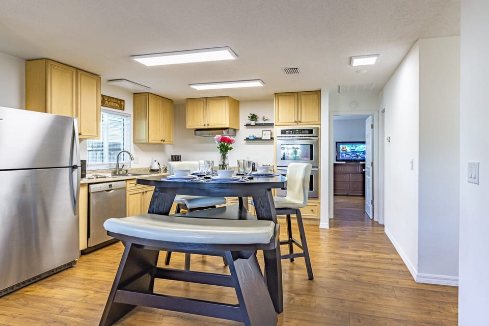 Open kitchen with stainless appliances (double oven & Bosch dishwasher). Look at those gorgeous floors!