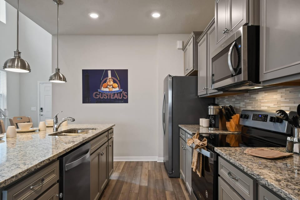 Modern Style Downstairs Area with Kitchen, Barstool Seating, and Living Room Lounge