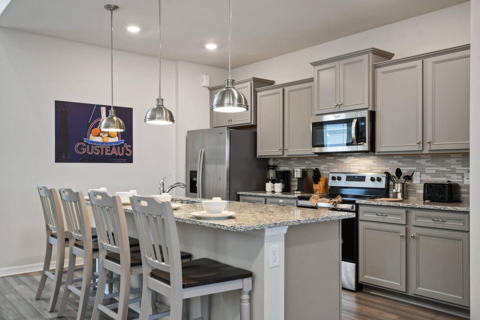 Modern Style Downstairs Area with Kitchen and Barstool Seating