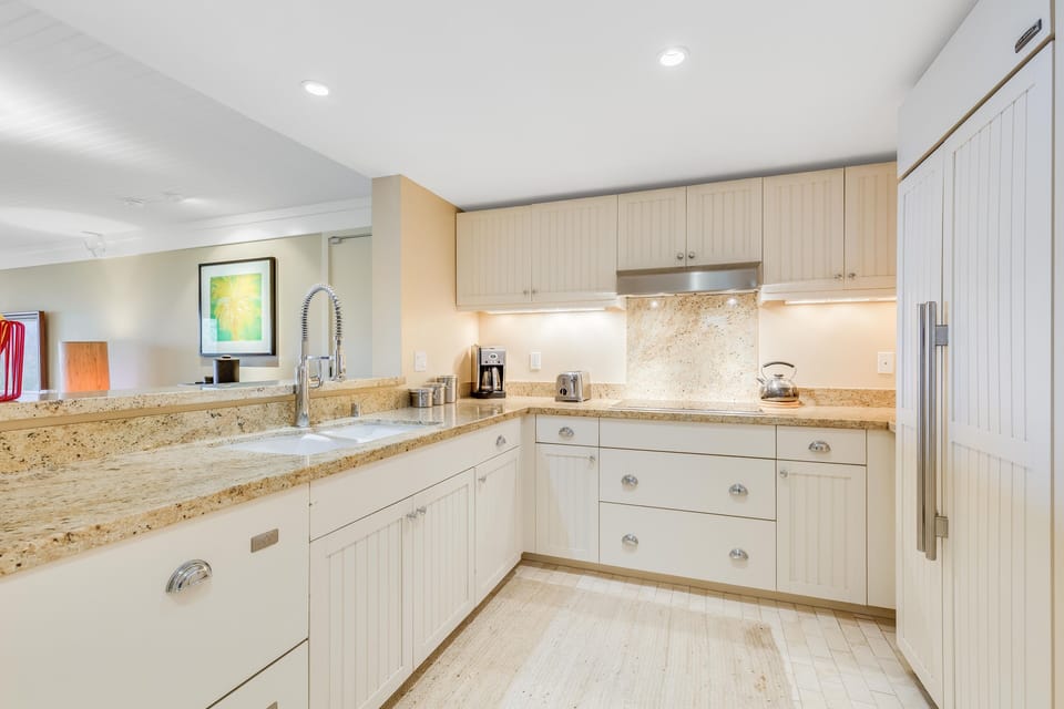Fully equipped kitchen with high-end appliances and granite countertops.