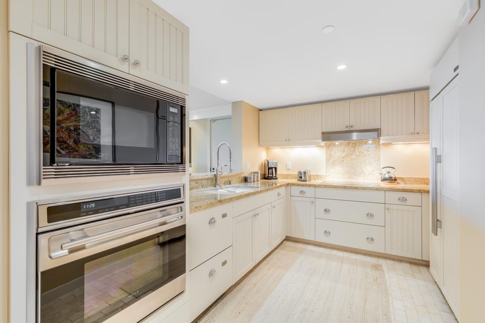 Well-appointed kitchen with stainless appliances, granite counters, and functional layout.