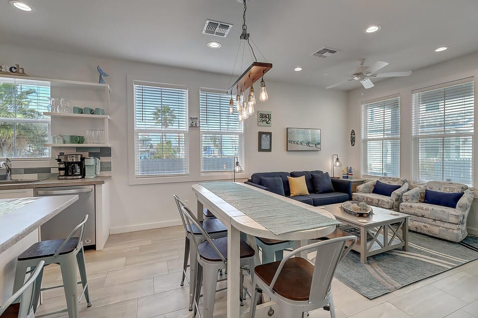 Unwind in this bright, open living space where natural light flows through large windows, creating the perfect atmosphere for relaxing.
