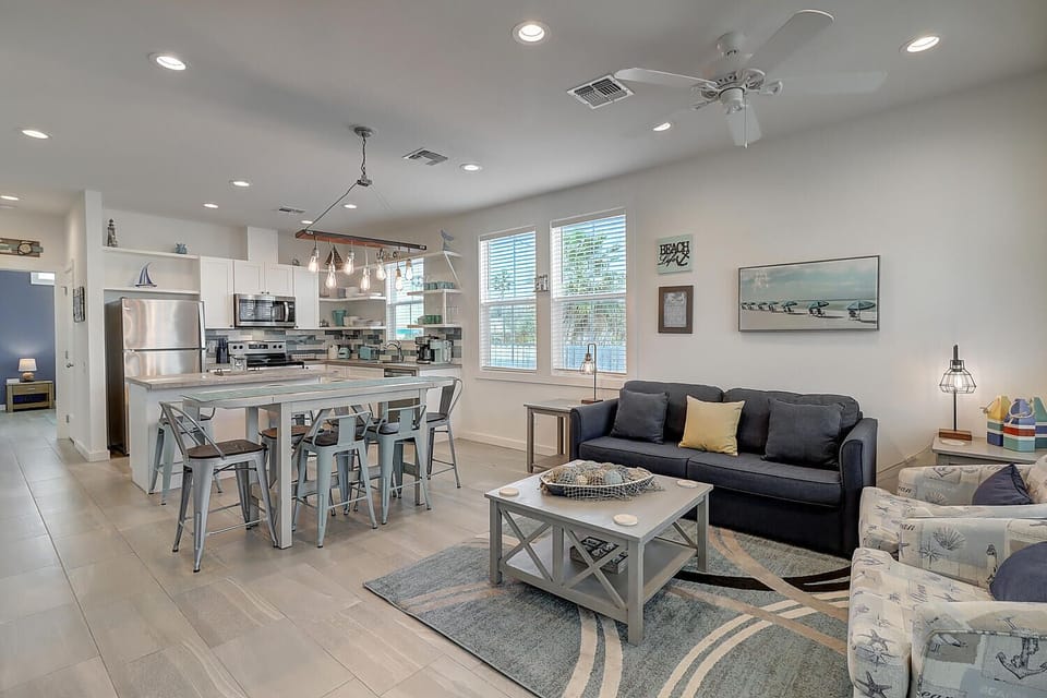 Unwind in your bright, open living space where modern coastal style meets comfort—complete with a fully equipped kitchen and cozy seating area.