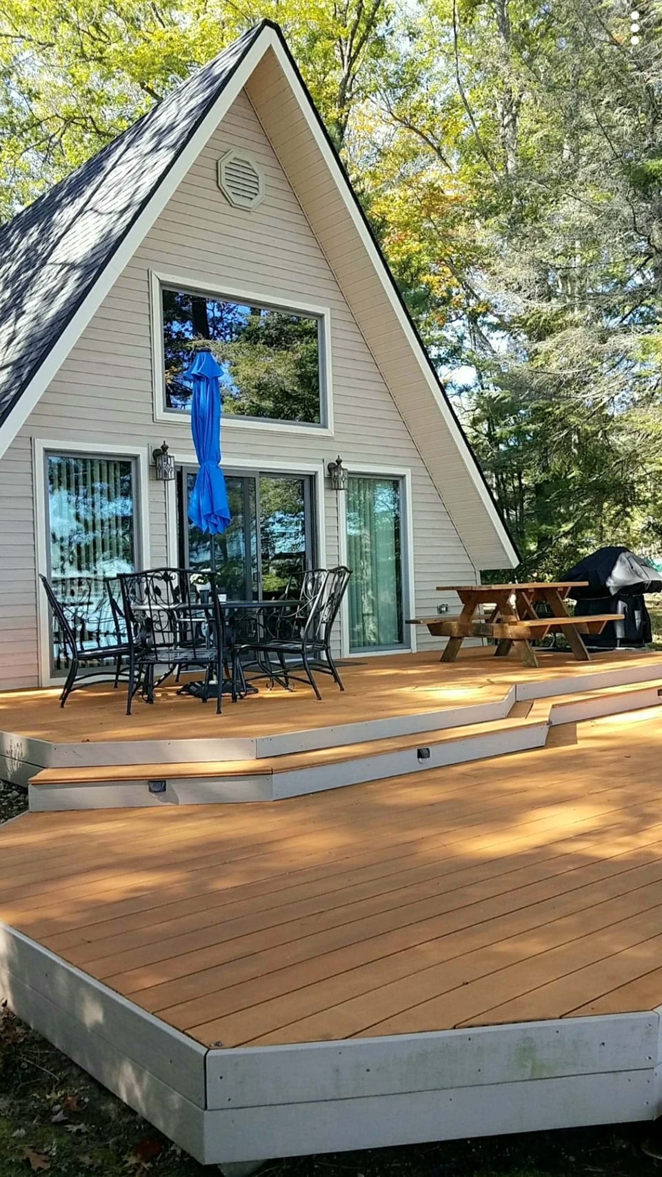 Large deck with beach chairs  and gas grill.