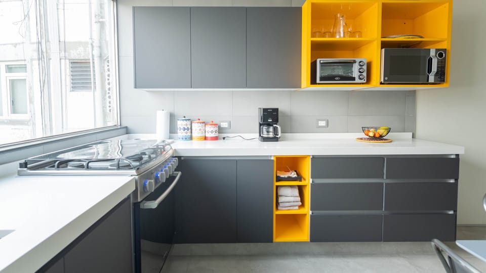Kitchen with new appliances: gas oven with six gas stoves, microwave, toaster