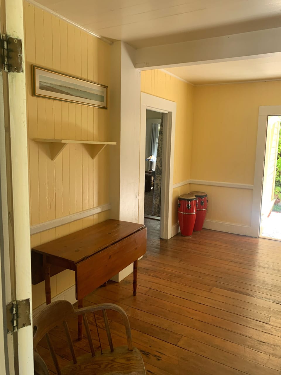 Kitchen table looking through dining room to living room and out front door.