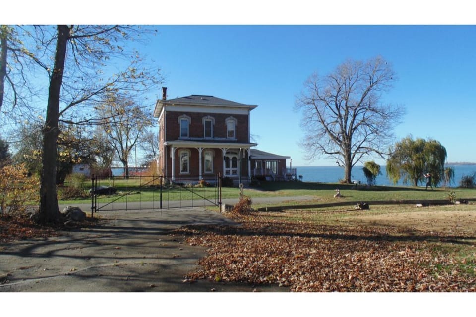 Front of house with view of Lake Erie behind. 