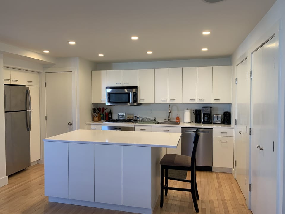 Full kitchen with stainless appliances, coffee maker, hot water kettle
