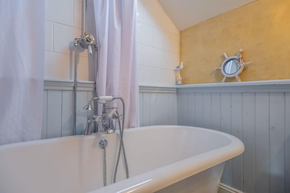 First floor: En-suite bathroom with roll top bath