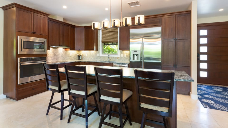 Gourmet kitchen with large island  that provides additional seating for four guests