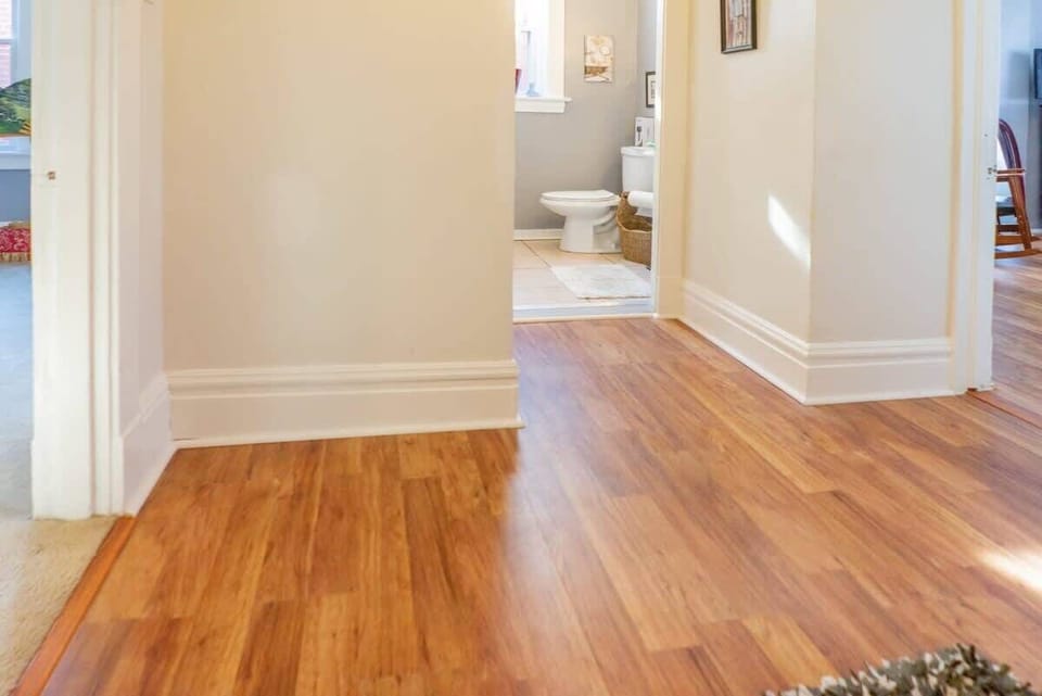This bright hallway connects seamlessly to a pristine bathroom and other welcoming spaces. #TravelConvenience 