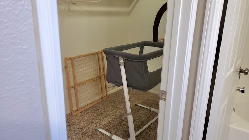Master Bedroom Closet with Portable Crib and Stair Gate